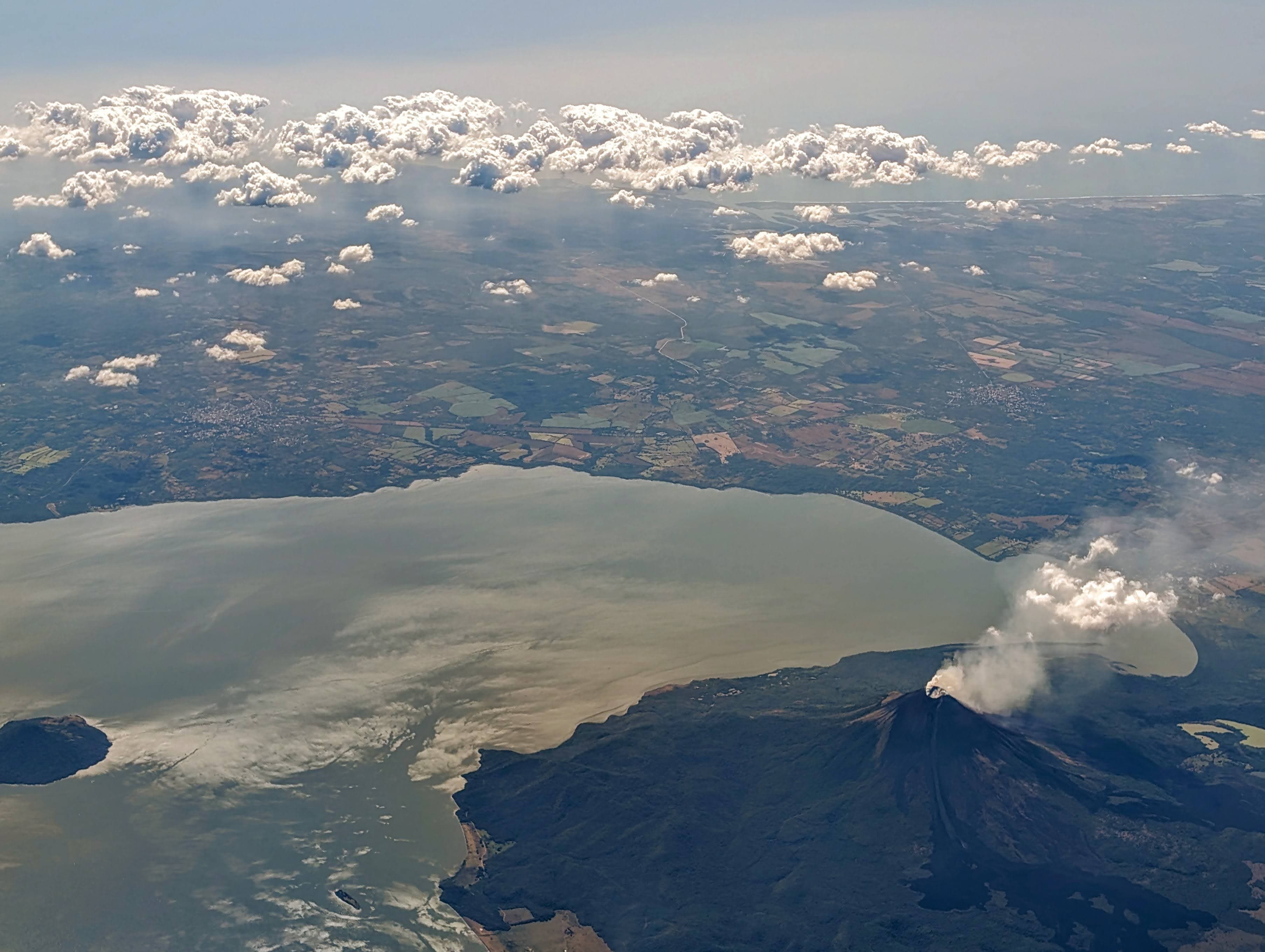 A smoking volcano beside a lake. Nicaragua.