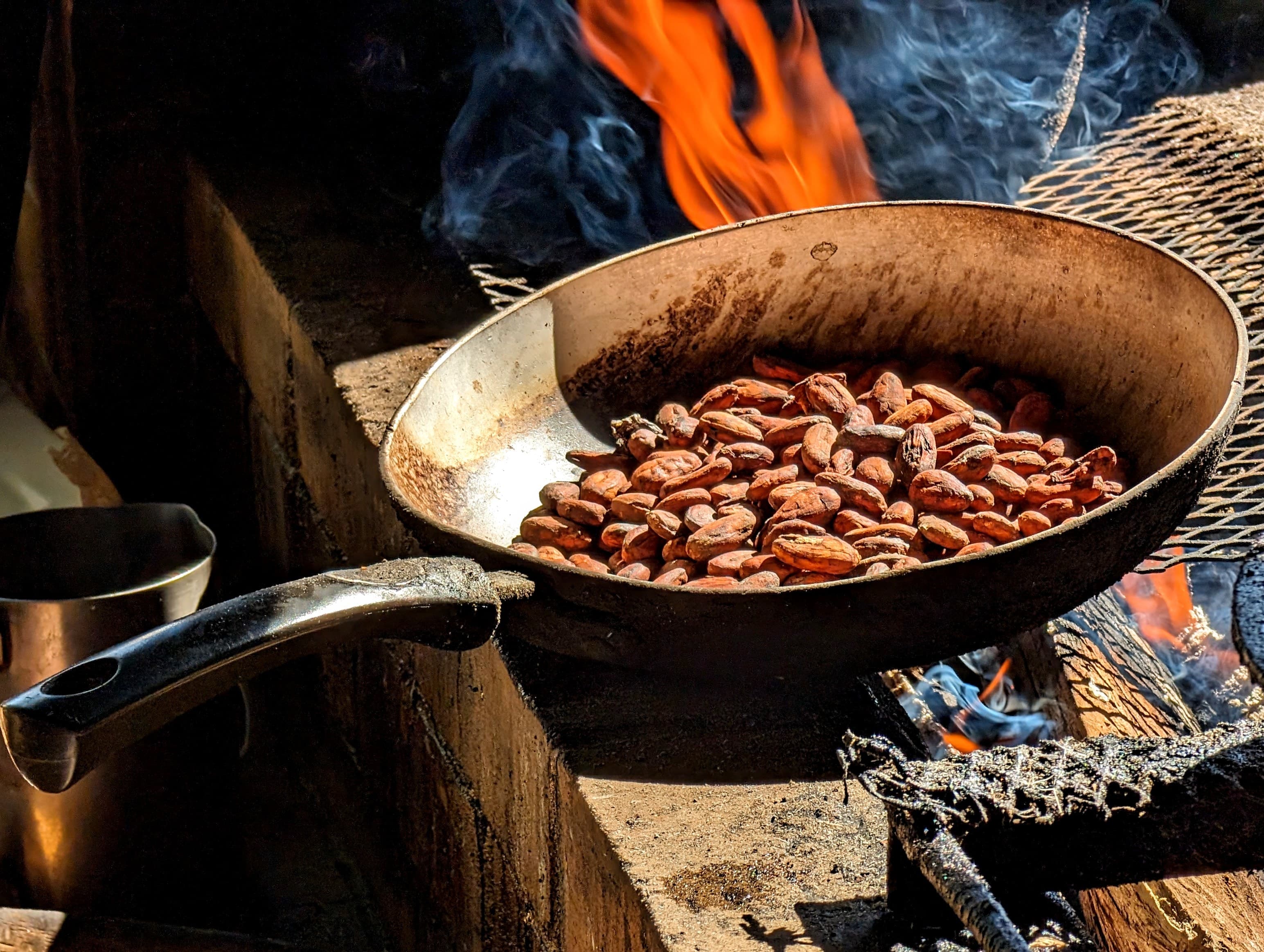 Cacao beans roasting over a fire. Guardia.