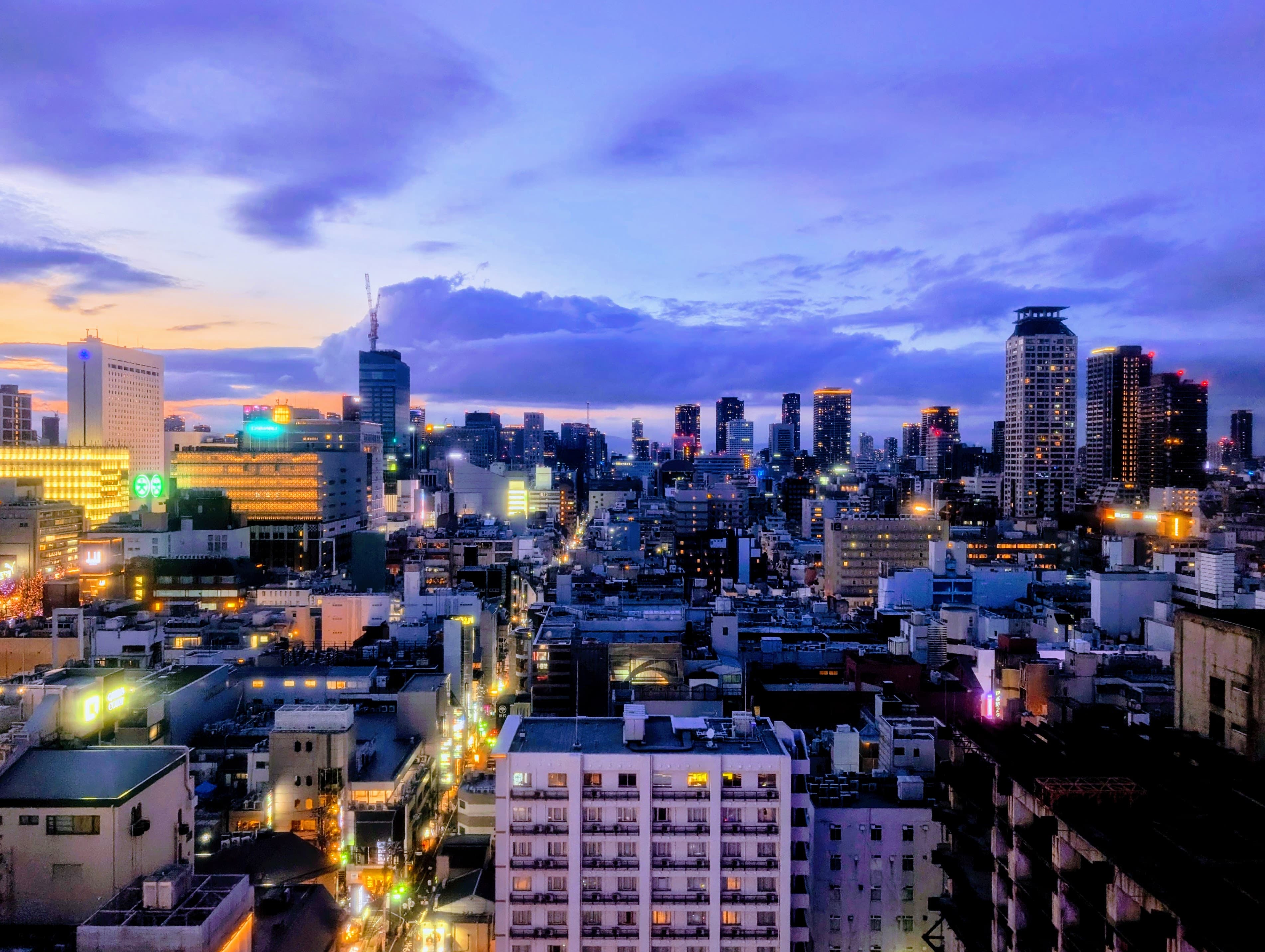 City lights beneath a purple evening sky.