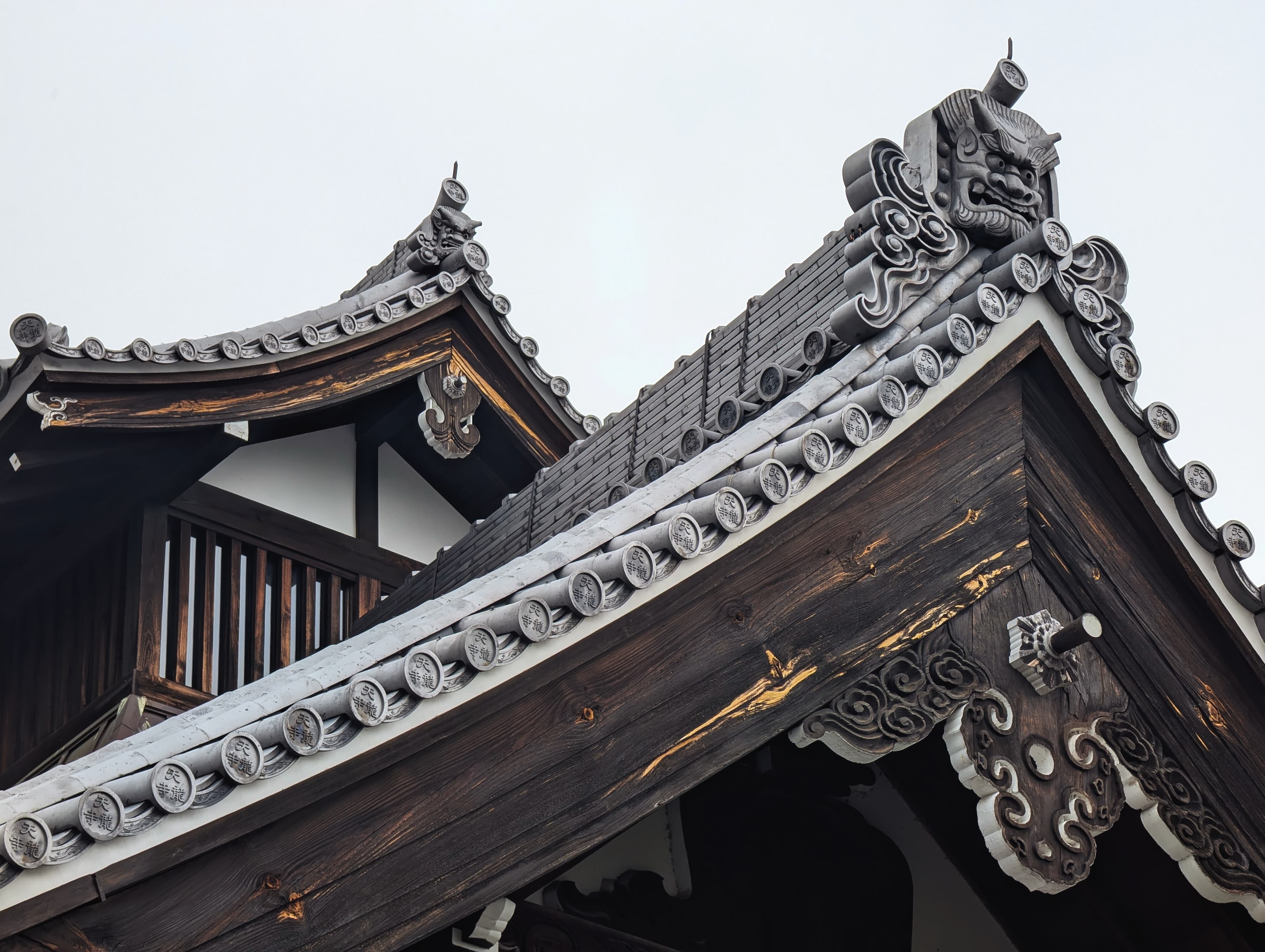 Decorative roof tiles and carved wood in Kyoto.