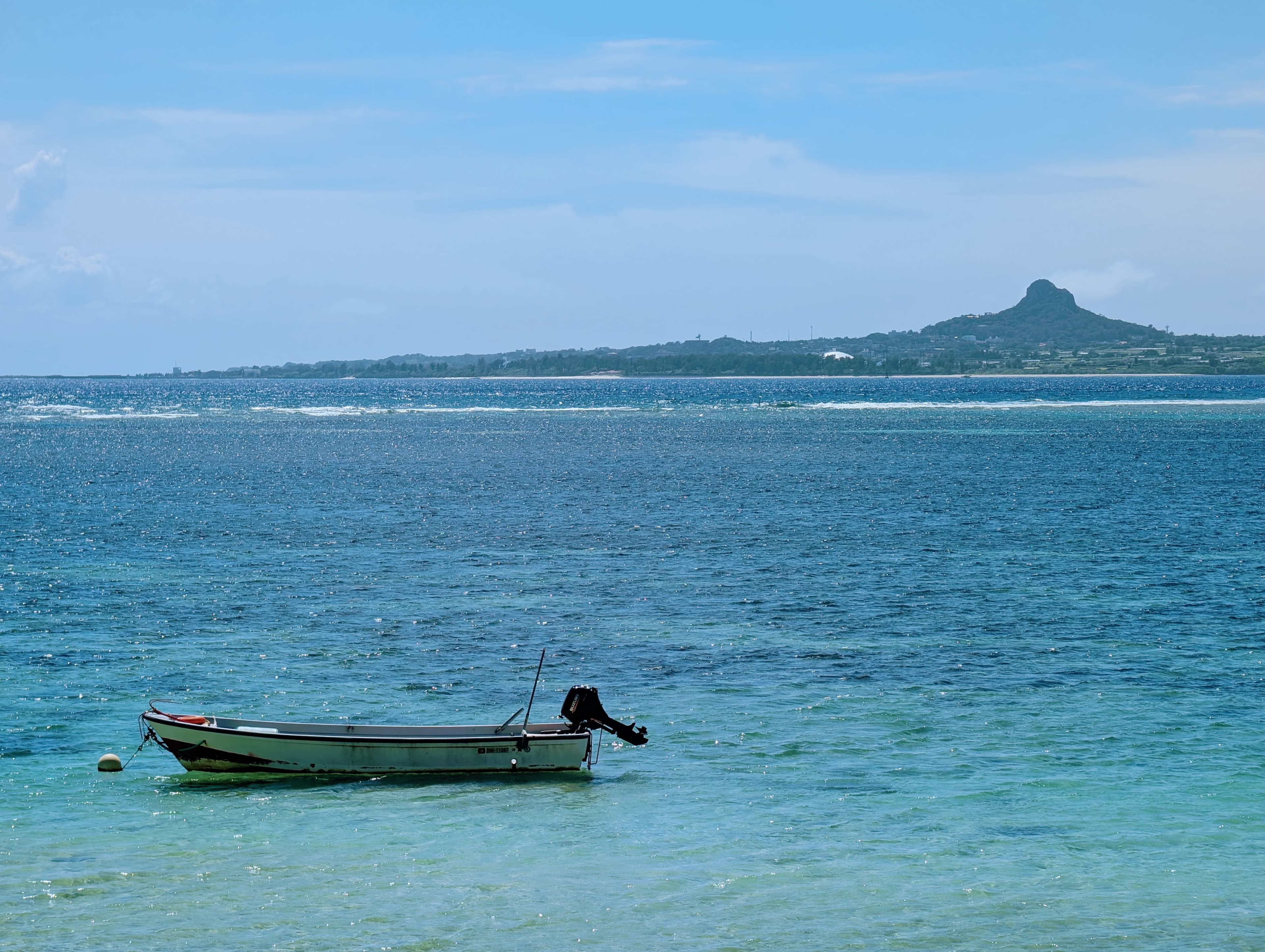 A small boat in the clear water off Motobu, Okinawa.