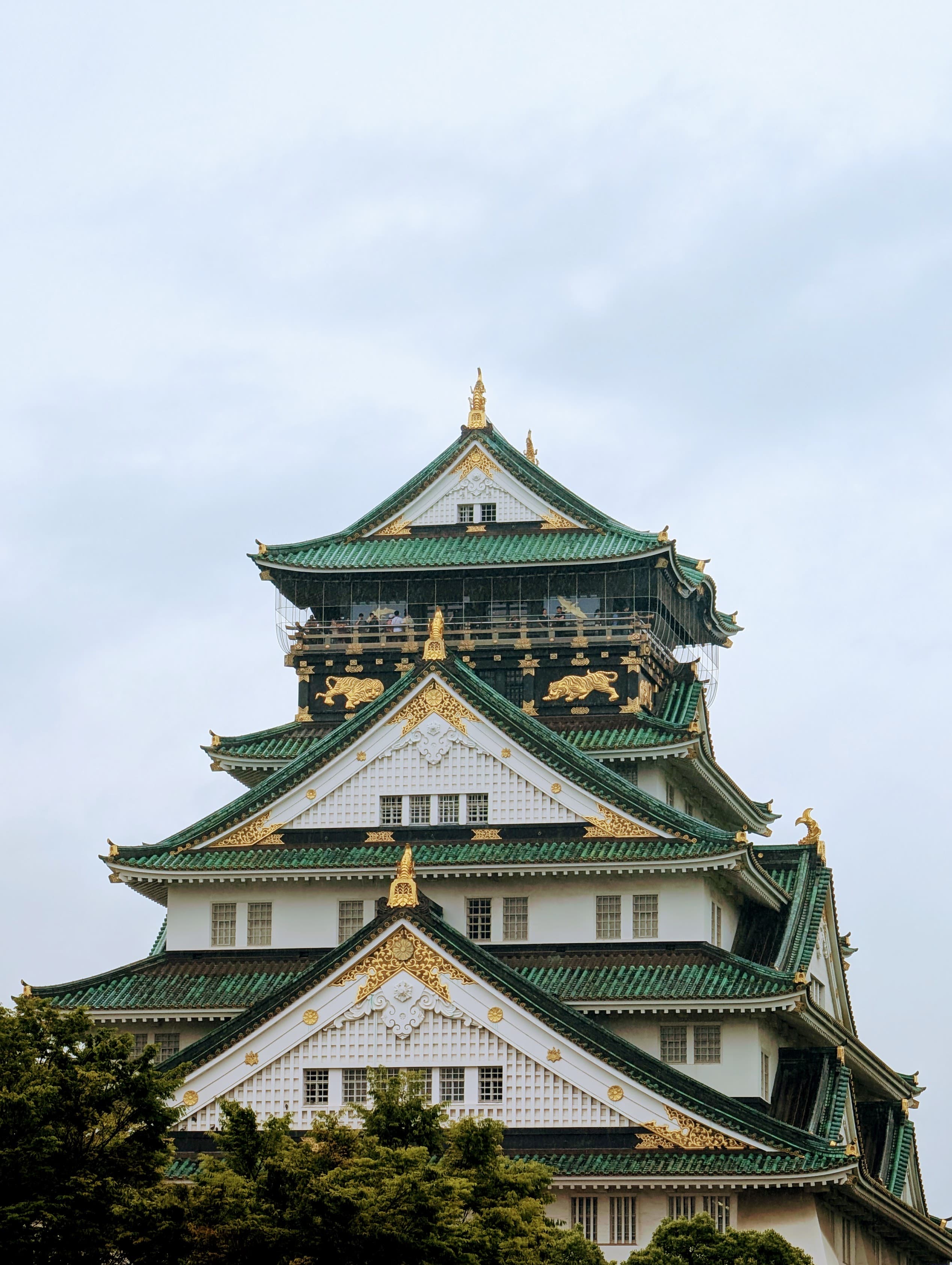 Osaka Castle beneath an overcast sky.