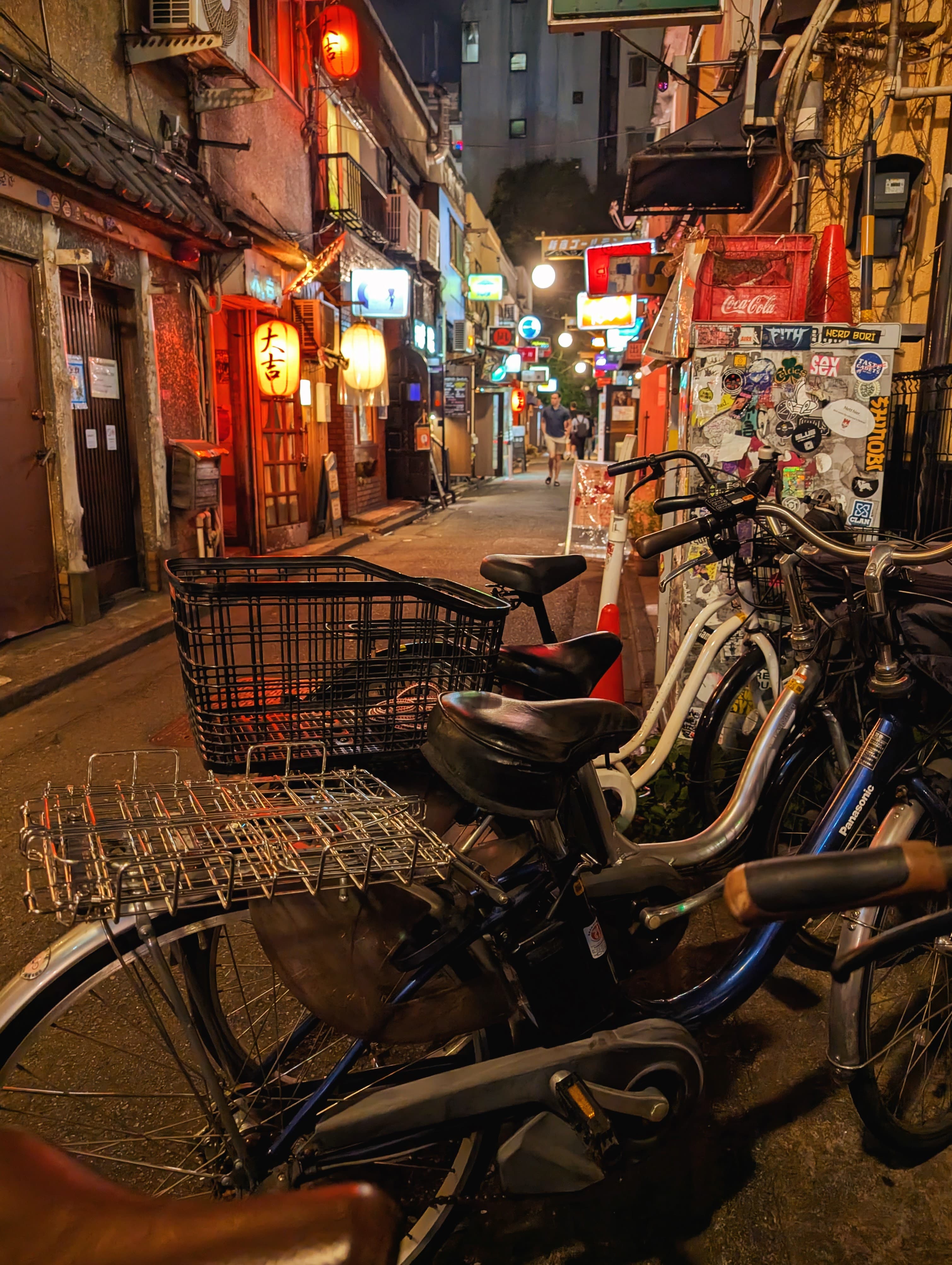Bicycles outside the small bars of Golden Gai at night.
