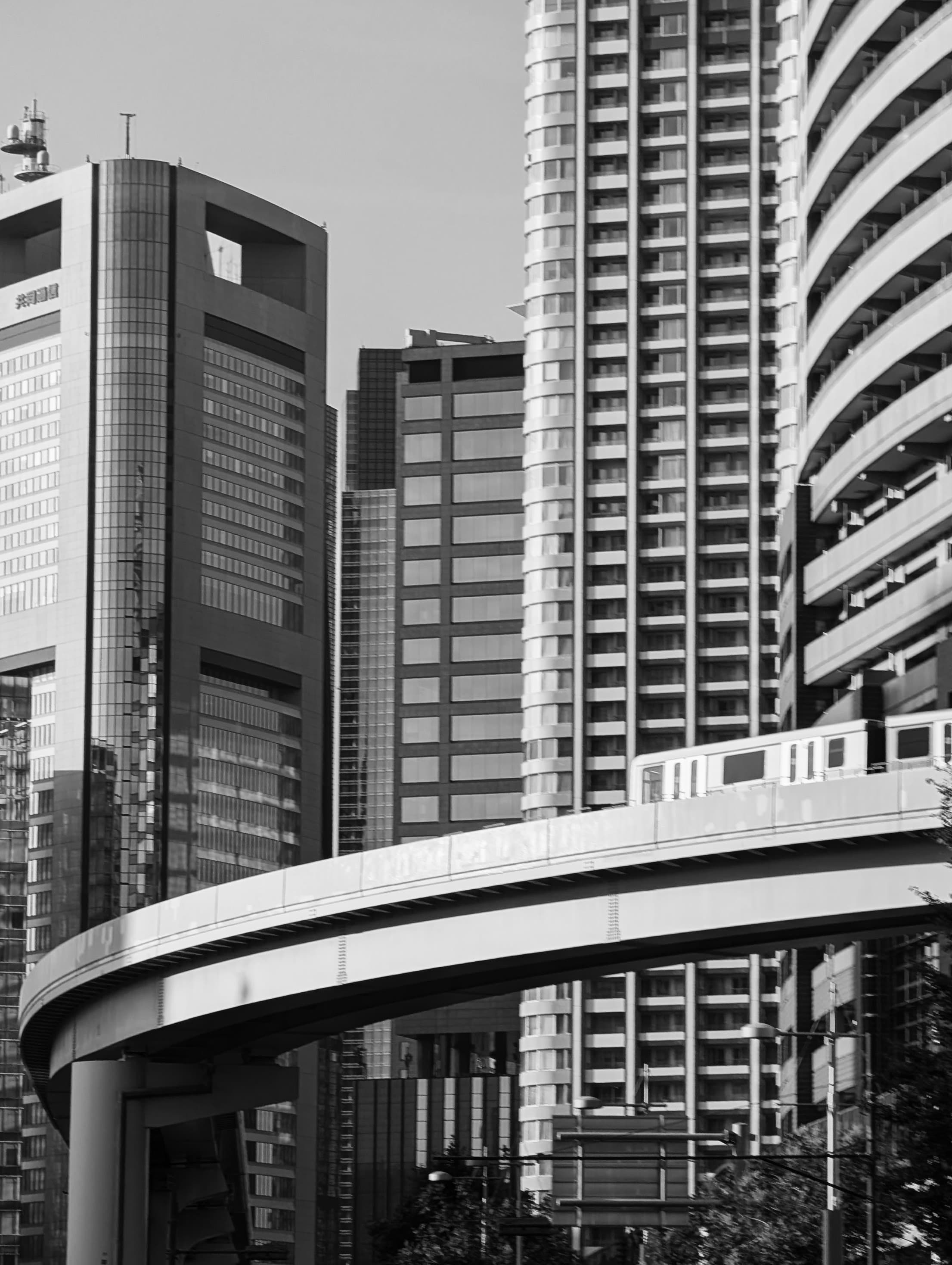 An elevated train curving between Tokyo’s buildings.